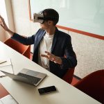 Man exploring office in virtual reality goggles